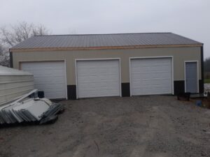 A metal building with two doors and a hybrid roof.